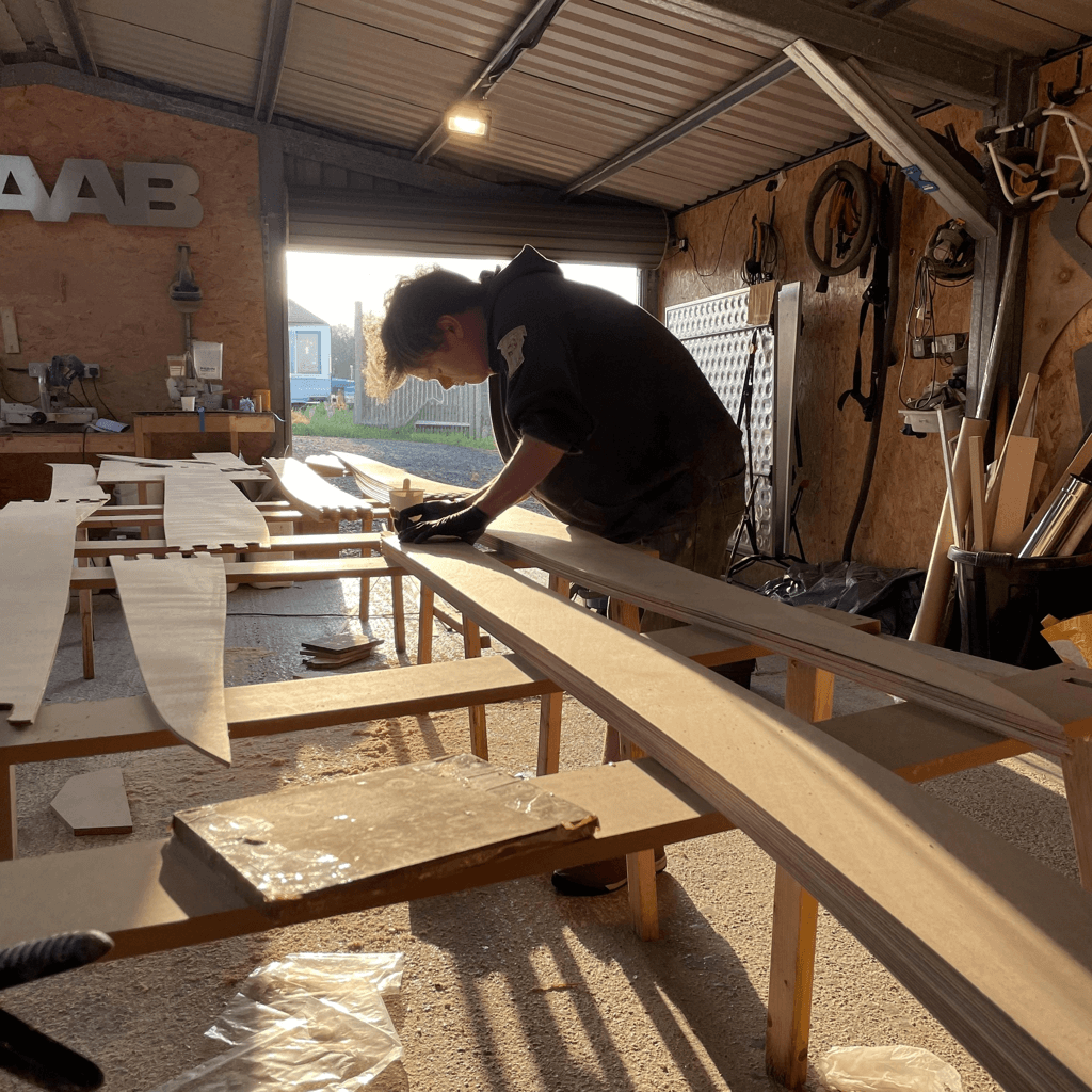 A local craftsperson shaping timber for a boat build in a Mull workshop.