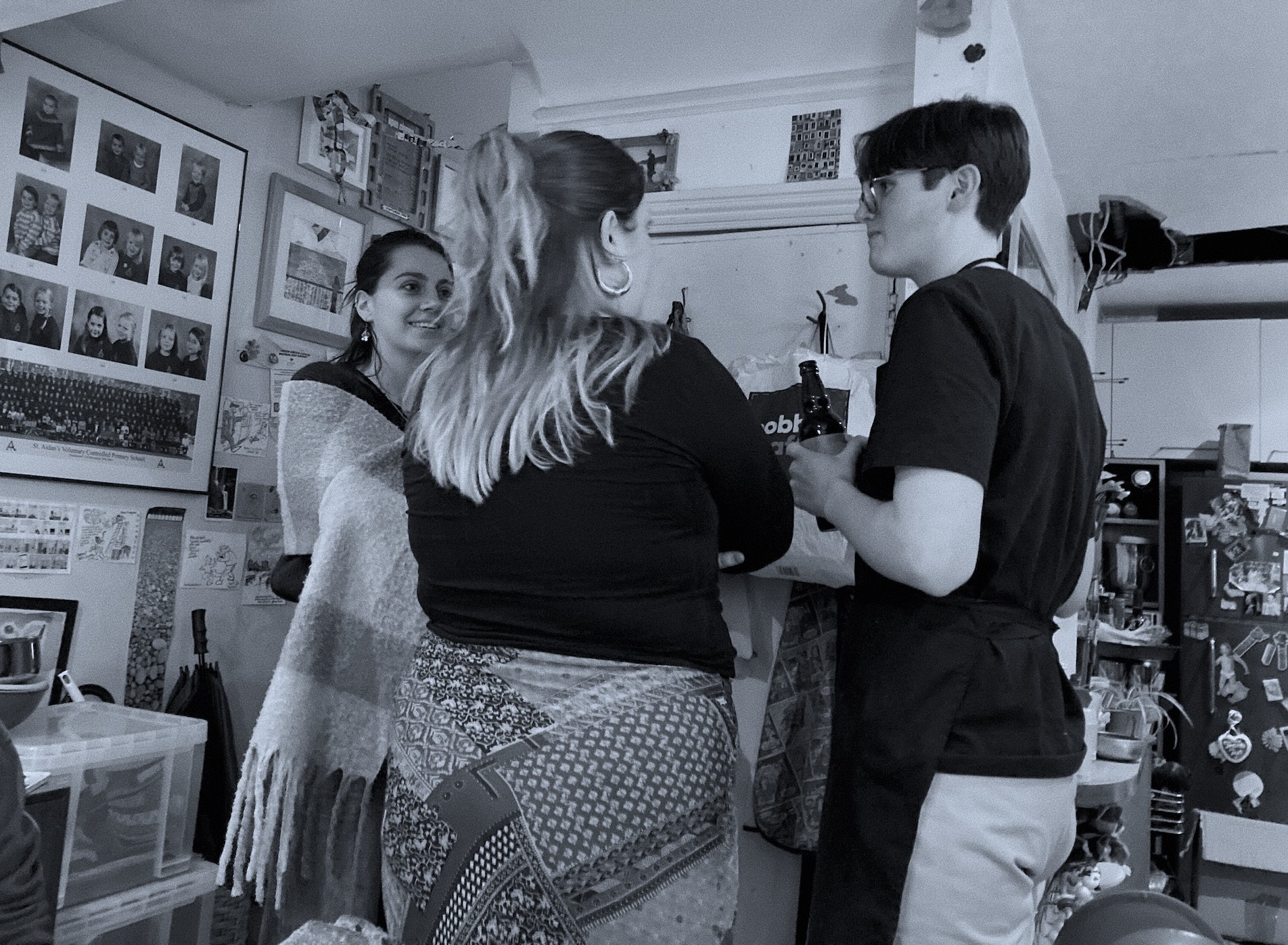 Three people in conversation in a kitchen, part of how the Clarity Lab team works together.